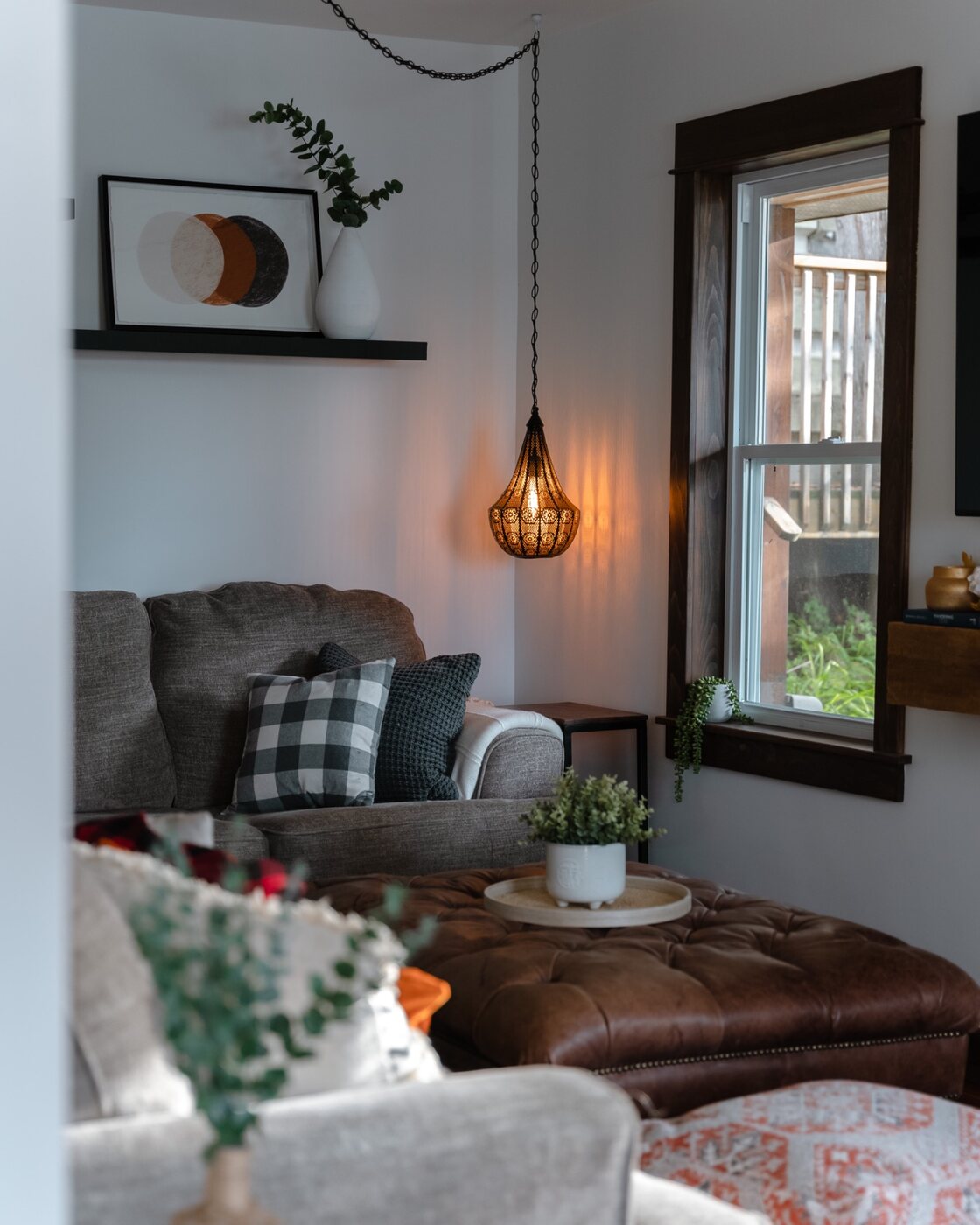 Cozy living room with warm pendant lighting and lake-house decor